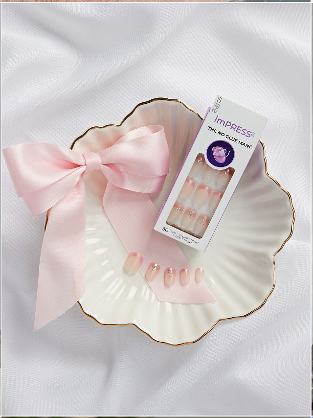 imPRESS nails with a pink ribbon on a shell dish